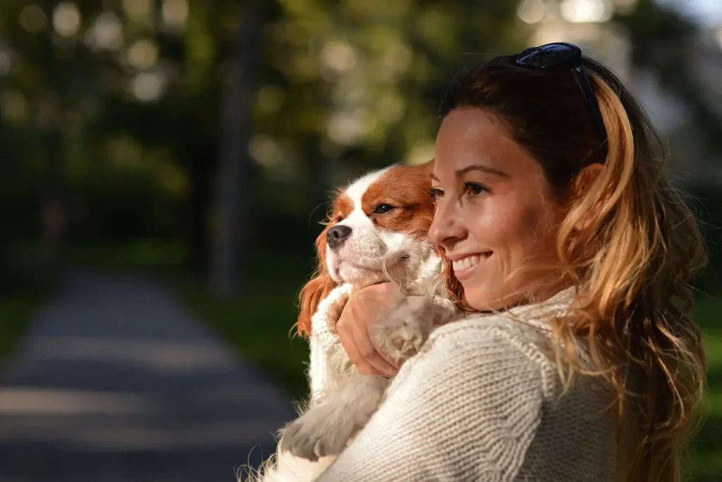 girl holding dog in her arms