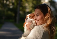 girl holding dog in her arms