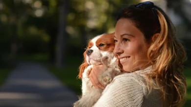 girl holding dog in her arms